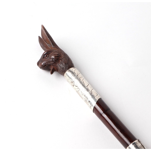 59 - A Victorian partridge wood swordstick with silver collars and a carved softwood mechanical head in t... 