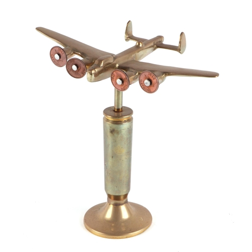 61 - A trench art brass cast model of Wellington Bomber, mounted on a brass plinth, wingspan 20cm.