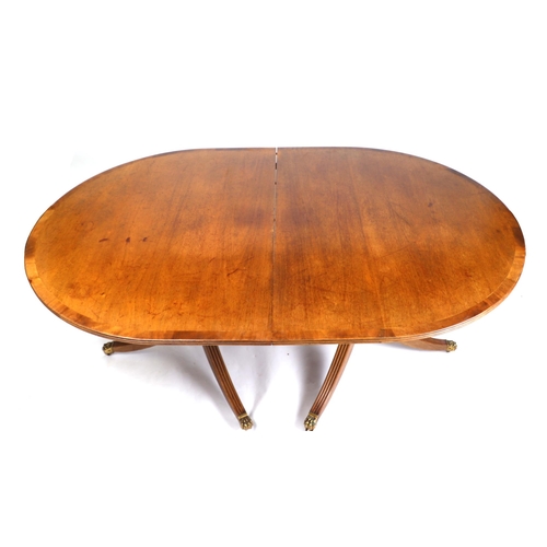 677 - A mahogany D-end twin pedestal dining table, with one extra leaf, 110 by 232cm extended.