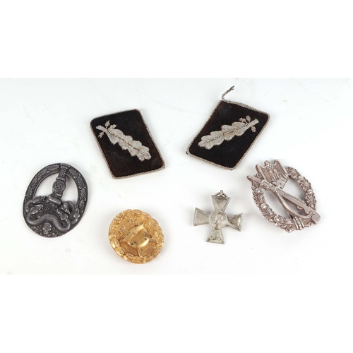 68 - A group of German Third Reich badges and other items.