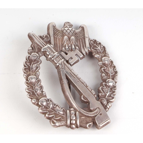 68 - A group of German Third Reich badges and other items.