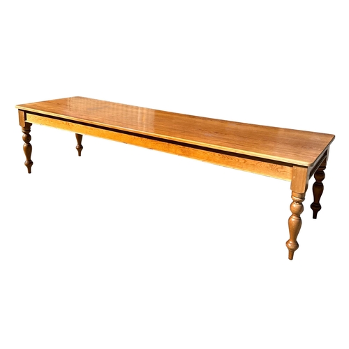 698 - A Victorian style large pine kitchen table on turned legs, 91 by 305cms.