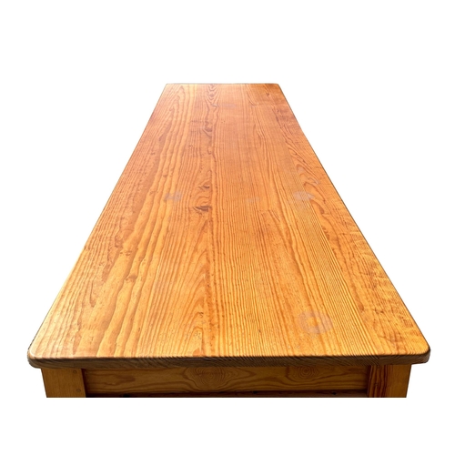 698 - A Victorian style large pine kitchen table on turned legs, 91 by 305cms.