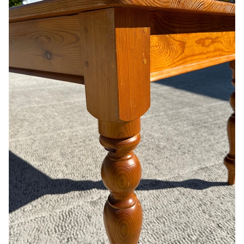 698 - A Victorian style large pine kitchen table on turned legs, 91 by 305cms.