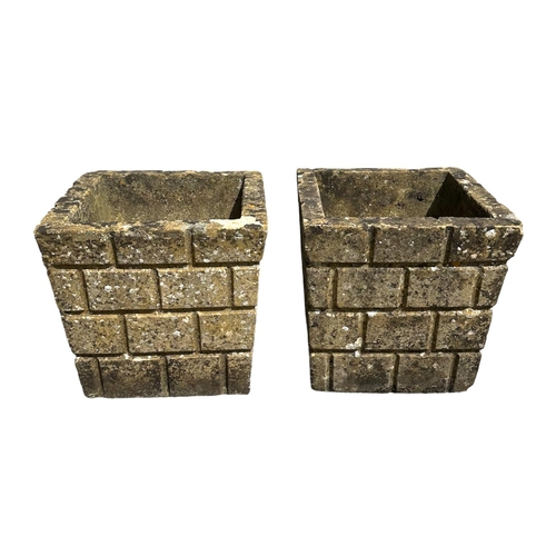 7 - A pair of well weathered reconstituted stone square form planters, 31cms wide (2).