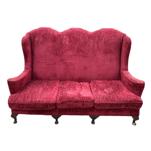 711 - A Queen Anne style three-seater sofa with arched back and scroll arms, on dwarf cabriole legs, 183cm... 