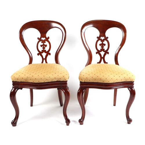 729 - A pair of Victorian mahogany balloon back side chairs with pierced back splats and overstuffed serpe... 