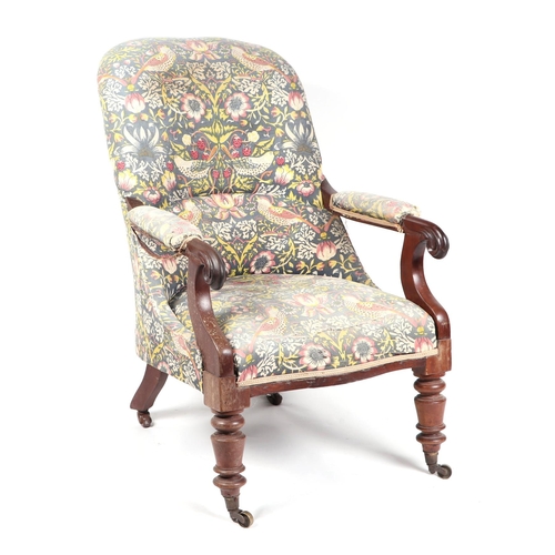 737 - A Victorian upholstered mahogany armchair on turned front supports.