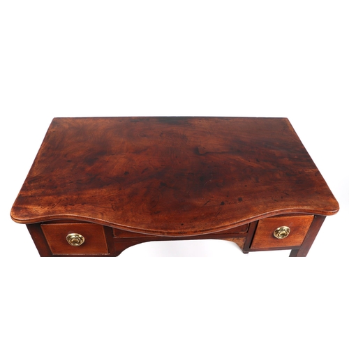 738 - A 19th century mahogany serpentine front side table, having an arrangement of three drawers on taper... 