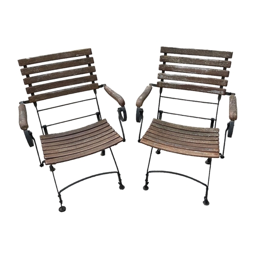 8 - A set of four folding slatted wooden and metal garden chairs (4).