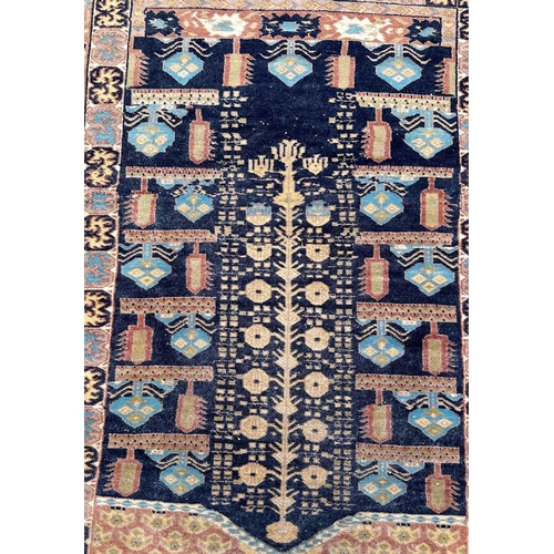 83 - A Persian hand knotted prayer rug with geometric design on a beige ground, 130 by 91cms.