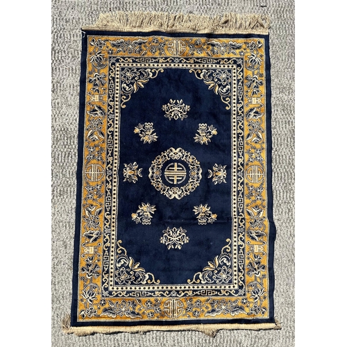 90 - A Chinese woollen rug with central foliate design within a floral border with censers, 93 by 60cms; ... 