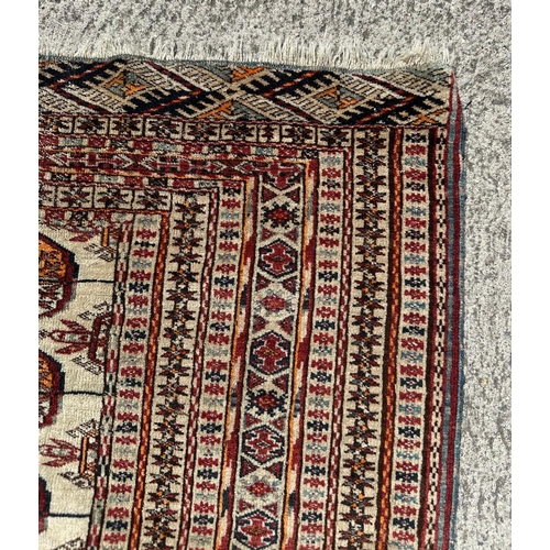 93 - A Persian Qashqai silk flatweave rug, the central repeated design within geometric borders, on a bei... 