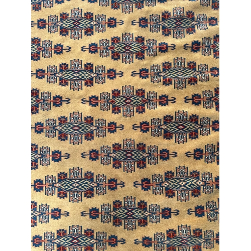 97 - A Persian silk flatweave rug with stylised repeat design within geometric borders, on a beige ground... 