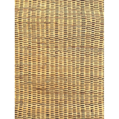 98 - An Indonesian woven rattan rug, 224cms wide.