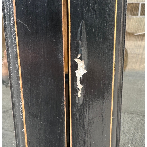 727 - A Chinese ebonised elm bookcase on cupboard in the European taste with a moulded cornice above a pai... 