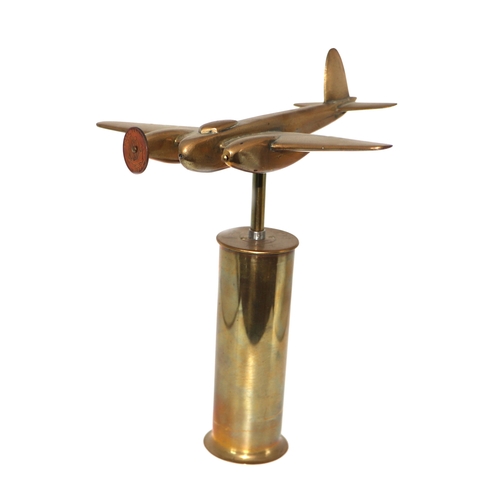 58 - A trench art cast brass model of a Mosquito aircraft, mounted on a brass plinth, wingspan 20cm.