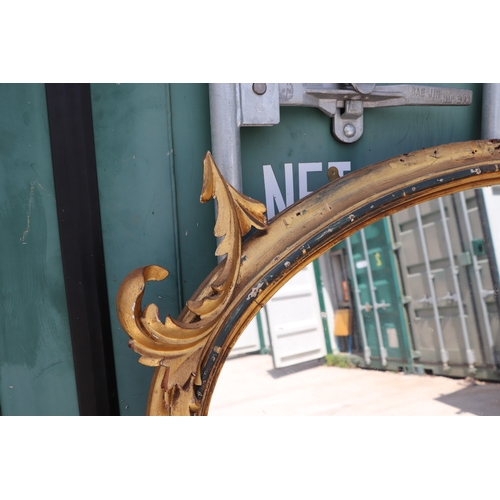 736 - A 19th century arched carved giltwood and gesso overmantle mirror, 125cms wide.