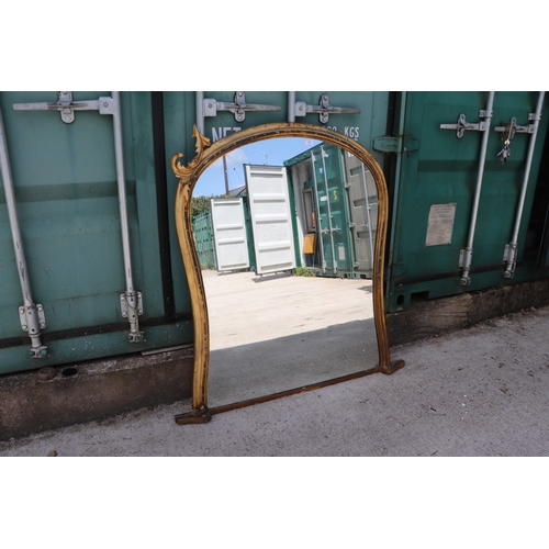 736 - A 19th century arched carved giltwood and gesso overmantle mirror, 125cms wide.