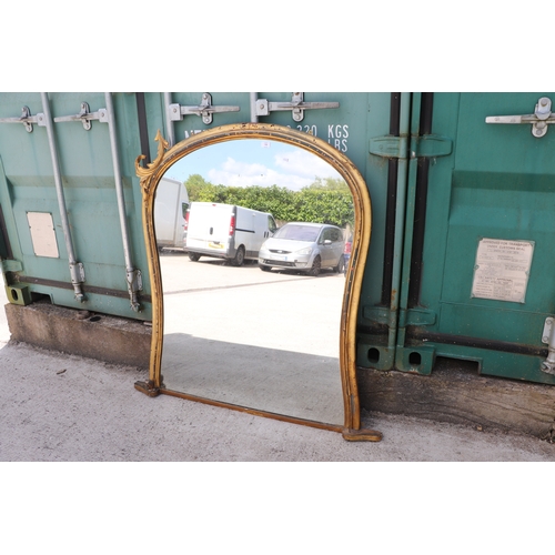 736 - A 19th century arched carved giltwood and gesso overmantle mirror, 125cms wide.