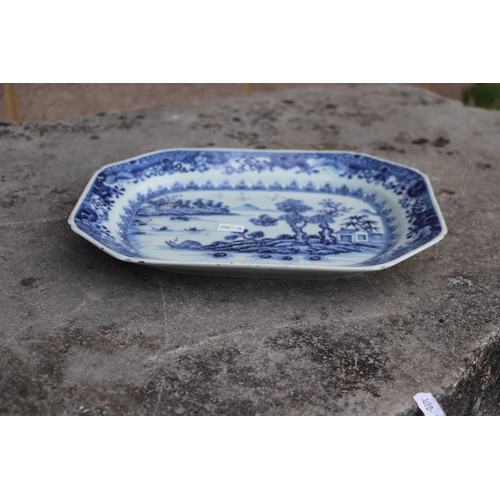 494 - An 18th century Chinese octagonal meat plate decorated with a river landscape scene, 31cms wide; tog... 