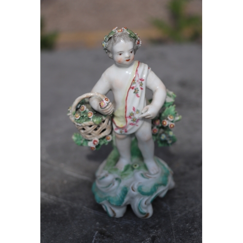 221 - A pair of Chelsea style porcelain figures holding baskets of flowers and having garlands of flowers ... 