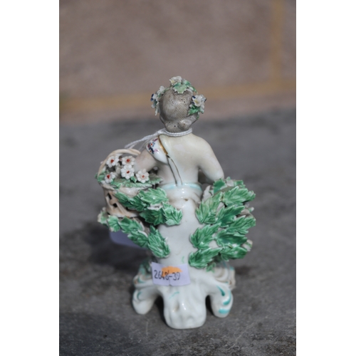 221 - A pair of Chelsea style porcelain figures holding baskets of flowers and having garlands of flowers ... 