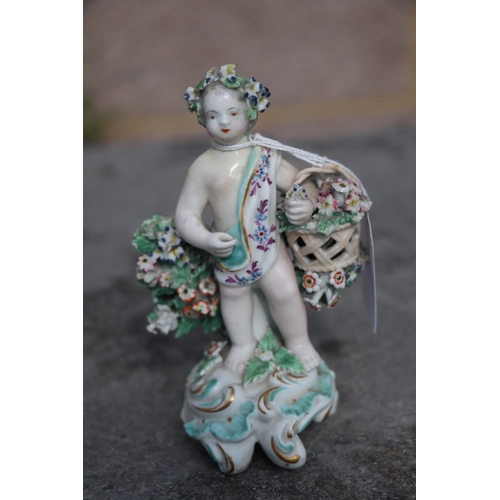 221 - A pair of Chelsea style porcelain figures holding baskets of flowers and having garlands of flowers ... 