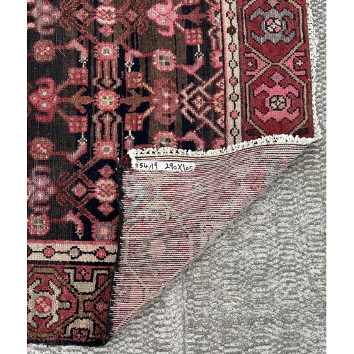 106 - A Persian Hamadan runner with repeating stylised floral design, on a red ground, 290 by 105cms.