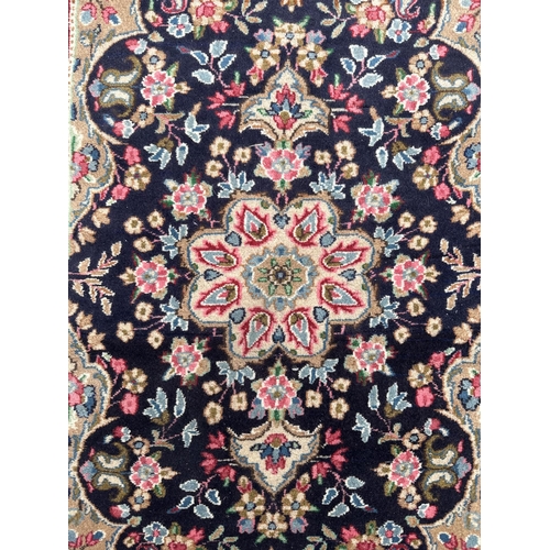 109 - A Persian Kerman carpet with central medallion and floral sprays within a floral and boteh border, o... 