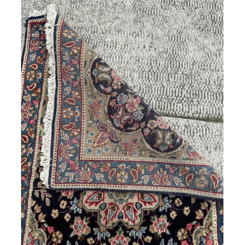 109 - A Persian Kerman carpet with central medallion and floral sprays within a floral and boteh border, o... 