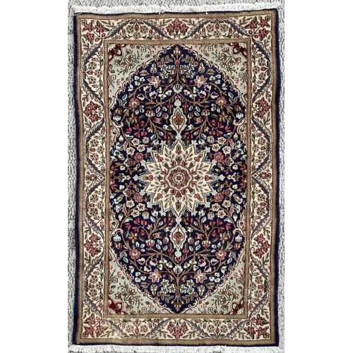 111 - A good quality Persian Kerman rug with central floral medallion within floral borders, on a cream gr... 