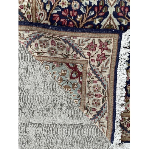 111 - A good quality Persian Kerman rug with central floral medallion within floral borders, on a cream gr... 