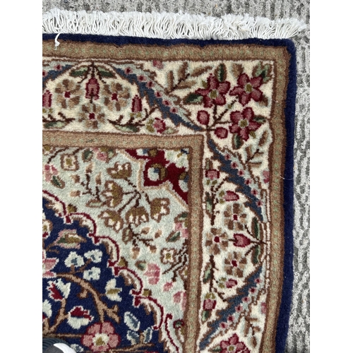 111 - A good quality Persian Kerman rug with central floral medallion within floral borders, on a cream gr... 