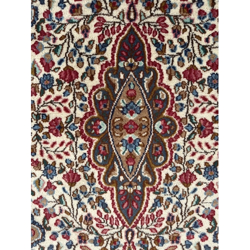 112 - A good quality Persian Kerman rug with stylised floral design and elongated central medallion, withi... 