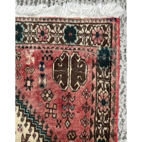 114 - A Persian hand knotted Shiraz runner with central medallion within rows of stylised animals and a fl... 