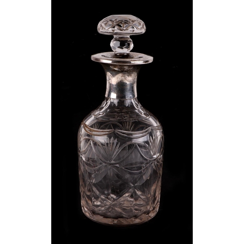 264 - A cut glass decanter with silver plated mount, 29cms high.