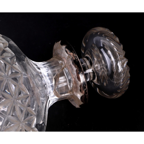 265 - A cut glass baluster form decanter with silver coloured metal collar, 20cms high (a/f).