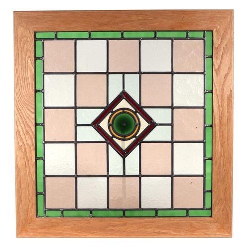 277 - A leaded stained glass panel in an oak frame, 48 by 50cms.