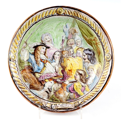 283 - A French faience pottery charger decorated with a tavern scene, with motto 'Par St Georges Je Te Fai... 