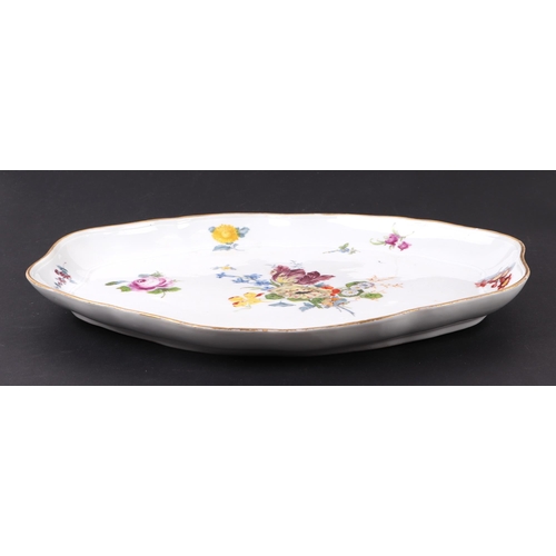 313 - A Meissen porcelain shaped oval shallow dish, hand decorated with sprays of flowers, 32cms wide.