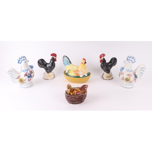 320 - A group of ceramic hens on nests; together with a group of continental pottery chicken jugs.