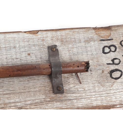 329 - A 19th century African tribal spear head mounted on a wooden plaque with inscription 'North African ... 