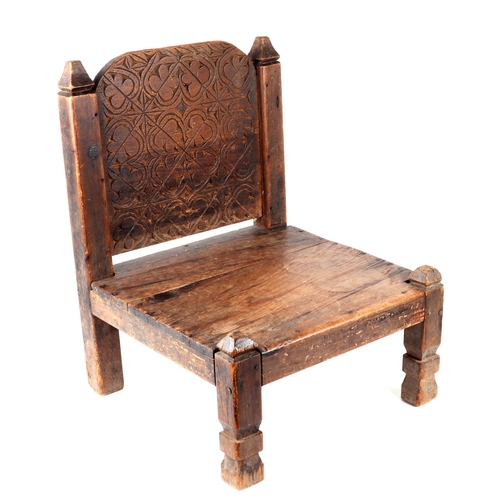 331 - An Afghan Khyber Pass Swat Valley tribal carved wooden low chair.