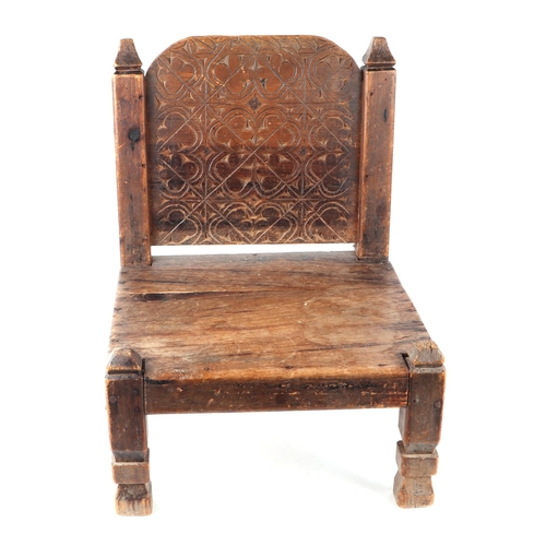 331 - An Afghan Khyber Pass Swat Valley tribal carved wooden low chair.