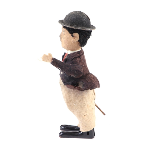 360 - An early 20th century Schuco clockwork model of Charlie Chaplin with fabric covered clothes, approx ... 