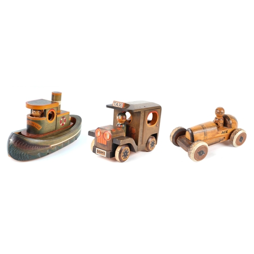 361 - Three carved and painted wooden toys to include a taxi, signed & dated 'Nic 86', 30cms, a racing car... 