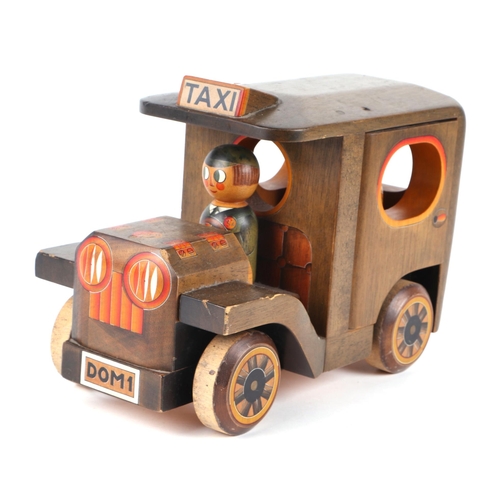 361 - Three carved and painted wooden toys to include a taxi, signed & dated 'Nic 86', 30cms, a racing car... 