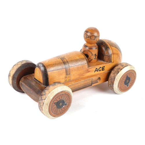 361 - Three carved and painted wooden toys to include a taxi, signed & dated 'Nic 86', 30cms, a racing car... 