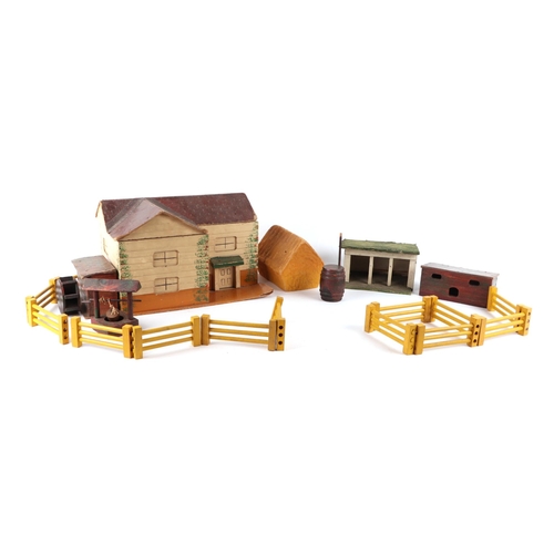 363 - An early 20th century toy farmhouse and buildings, 33cms wide.